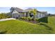 Inviting single-Gathering home with lush landscaping, a two-car garage, and a charming front porch seating area at 5938 164Th E Ave, Parrish, FL 34219