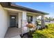Charming covered front porch with stone pillars, comfortable seating, and a beautifully landscaped garden at 5938 164Th E Ave, Parrish, FL 34219