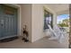 Inviting front porch features stone accents, a cozy seating area, and elegant decor, creating a welcoming entrance at 5938 164Th E Ave, Parrish, FL 34219