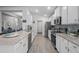 Bright kitchen with stainless appliances, white cabinets, granite countertops, and a gray tile backsplash at 5938 164Th E Ave, Parrish, FL 34219