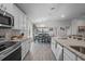 Open kitchen with stainless steel appliances, granite countertops, and a spacious dining area at 5938 164Th E Ave, Parrish, FL 34219