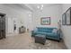 Bright living room with a comfortable blue sofa, stylish decor, and plenty of natural light at 5938 164Th E Ave, Parrish, FL 34219
