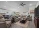 Spacious living room featuring comfortable seating, stylish decor, and an open layout to the kitchen at 5938 164Th E Ave, Parrish, FL 34219