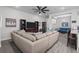 Spacious living room with a large sectional sofa, a ceiling fan and tile flooring throughout at 5938 164Th E Ave, Parrish, FL 34219