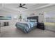The primary bedroom with a tray ceiling features carpet, windows and a beautifully styled bed at 5938 164Th E Ave, Parrish, FL 34219