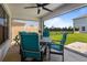 Covered patio features outdoor seating and ceiling fan overlooking the backyard at 5938 164Th E Ave, Parrish, FL 34219