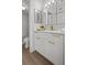 Bathroom vanity with white cabinets, white countertop and gold hardware at 6051 Sun Blvd # 111, St Petersburg, FL 33715
