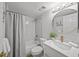 Updated bathroom with modern fixtures, round mirror, and shower/tub combo at 6051 Sun Blvd # 111, St Petersburg, FL 33715