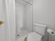 Clean bathroom with white marble-look tiled shower and new toilet at 6051 Sun Blvd # 111, St Petersburg, FL 33715