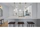 Bright, updated kitchen featuring a large island with bar seating, white cabinets, quartz countertops, and modern stainless steel appliances at 6051 Sun Blvd # 111, St Petersburg, FL 33715