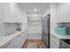 Modern kitchen featuring white cabinets, stainless steel appliances, quartz countertops, and ample storage for culinary enthusiasts at 6051 Sun Blvd # 111, St Petersburg, FL 33715