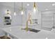 Bright kitchen featuring stylish pendant lighting, quartz countertops, stainless steel appliances, and modern white cabinetry at 6051 Sun Blvd # 111, St Petersburg, FL 33715