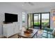 Living room with screened lanai, water view, and comfortable seating area at 6051 Sun Blvd # 111, St Petersburg, FL 33715