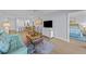 Open-concept living area with modern furnishings and an adjacent bedroom and kitchen at 6051 Sun Blvd # 111, St Petersburg, FL 33715
