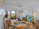 Living room with dining area, screened lanai, water view, and comfortable seating area at 6051 Sun Blvd # 111, St Petersburg, FL 33715