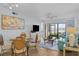 Living room with dining area, screened lanai, water view, and comfortable seating area at 6051 Sun Blvd # 111, St Petersburg, FL 33715