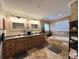 This bathroom features a granite double vanity, a jacuzzi tub, crown moulding, and a separate towel rack at 6805 Monet Cir, Temple Terrace, FL 33617