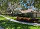 Charming single-story home with a well-manicured lawn and mature trees at 6805 Monet Cir, Temple Terrace, FL 33617