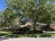 Traditional home with lush landscaping, mature shade trees and a two-car garage at 6805 Monet Cir, Temple Terrace, FL 33617