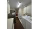 Efficient laundry room with washer, dryer, and ample white cabinet storage space at 6805 Monet Cir, Temple Terrace, FL 33617