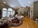 Bright living room with hardwood floors, large windows offering a view, and a cozy seating arrangement at 6805 Monet Cir, Temple Terrace, FL 33617