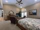 Primary suite boasts vaulted ceilings, serene ambiance, neutral carpet, transom windows, and comfortable sitting area at 6805 Monet Cir, Temple Terrace, FL 33617