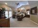This primary bedroom features vaulted ceilings, and access to the lanai, plus comfortable seating and ample natural light at 6805 Monet Cir, Temple Terrace, FL 33617