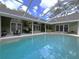Enjoy a private outdoor space with large pool, screened lanai and ample patio seating for entertaining at 6805 Monet Cir, Temple Terrace, FL 33617
