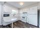 Bright kitchen features all white cabinets, updated countertops and flooring with a breakfast bar at 6935 Monte Carlo N, Pinellas Park, FL 33781