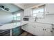 Updated kitchen with bright white cabinets, countertops, flooring and stainless steel appliances at 6935 Monte Carlo N, Pinellas Park, FL 33781