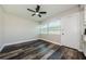 A brightly lit open-concept living room with wood-look floors, a ceiling fan and access to the outside at 6935 Monte Carlo N, Pinellas Park, FL 33781