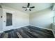 A bright and neutral living room with a ceiling fan, wood-look floors, and access to the outside at 6935 Monte Carlo N, Pinellas Park, FL 33781