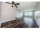 A neutral living room with a ceiling fan and new wood-look flooring at 6935 Monte Carlo N, Pinellas Park, FL 33781