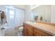 Bathroom featuring a shower and tub combination, toilet, and wooden vanity with a large mirror at 7051 Dartmouth N Ave, St Petersburg, FL 33710