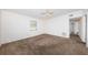 Bright, spacious bedroom with neutral carpet, white walls, and a ceiling fan at 7051 Dartmouth N Ave, St Petersburg, FL 33710