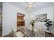 Bright dining area with a glass table and modern chairs, with a view into the kitchen at 7051 Dartmouth N Ave, St Petersburg, FL 33710