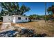 Home exterior featuring green space, and palm trees, offering privacy and outdoor potential at 7051 Dartmouth N Ave, St Petersburg, FL 33710
