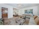 Open-concept living room with seamless connection to the dining area at 7051 Dartmouth N Ave, St Petersburg, FL 33710