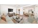 Living room furnished with neutral-toned furniture, TV, rug and modern decor at 7051 Dartmouth N Ave, St Petersburg, FL 33710