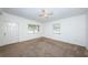 Inviting living room with neutral carpet, white walls, and bright, natural light at 7051 Dartmouth N Ave, St Petersburg, FL 33710