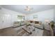 Bright living room with neutral furniture, a ceiling fan, and natural light from the windows at 7051 Dartmouth N Ave, St Petersburg, FL 33710
