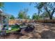 Backyard with patio area, seating, grass and mulch landscaping with a wood fence at 7311 N Dartmouth Ave, Tampa, FL 33604