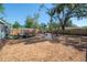 Large backyard with wood chip ground cover, wood fence, and seating areas at 7311 N Dartmouth Ave, Tampa, FL 33604