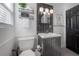 Bathroom with a vanity, toilet, and decoratively tiled wall at 7311 N Dartmouth Ave, Tampa, FL 33604