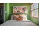 Bright bedroom features decorative pillows, a headboard and natural light at 7311 N Dartmouth Ave, Tampa, FL 33604