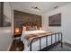 Stylish bedroom with a wood accent wall, cozy linens, and decorative lamps at 7311 N Dartmouth Ave, Tampa, FL 33604