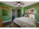 Comfortable bedroom with hardwood floors, stylish decor and natural lighting at 7311 N Dartmouth Ave, Tampa, FL 33604