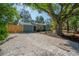 Quaint home exterior with a well-maintained walkway, rock driveway, and neatly landscaped garden beds featuring colorful plants at 7311 N Dartmouth Ave, Tampa, FL 33604