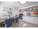 Well-lit kitchen featuring stainless appliances, a dining area, and an open concept design at 7311 N Dartmouth Ave, Tampa, FL 33604
