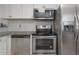Modern kitchen features stainless steel appliances, sleek countertops, and ample cabinet space at 7311 N Dartmouth Ave, Tampa, FL 33604
